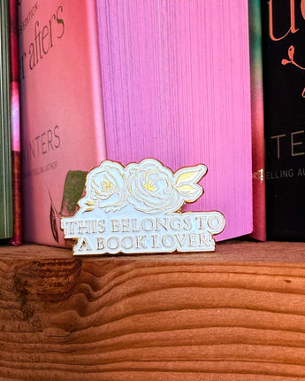 Pin on a wooden surface with books in the background